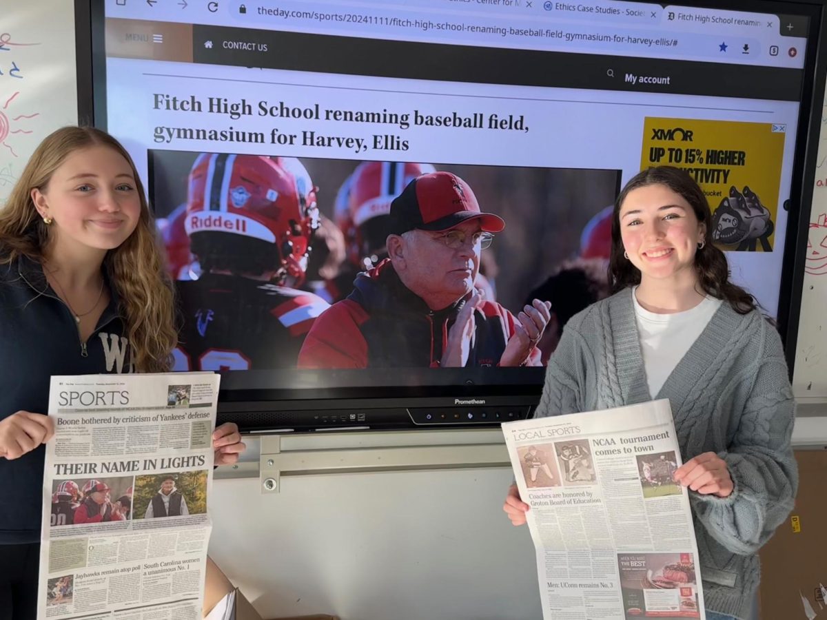 Avery Horan and Millie DeBell of the Falcon Press pose with their article for The Day.