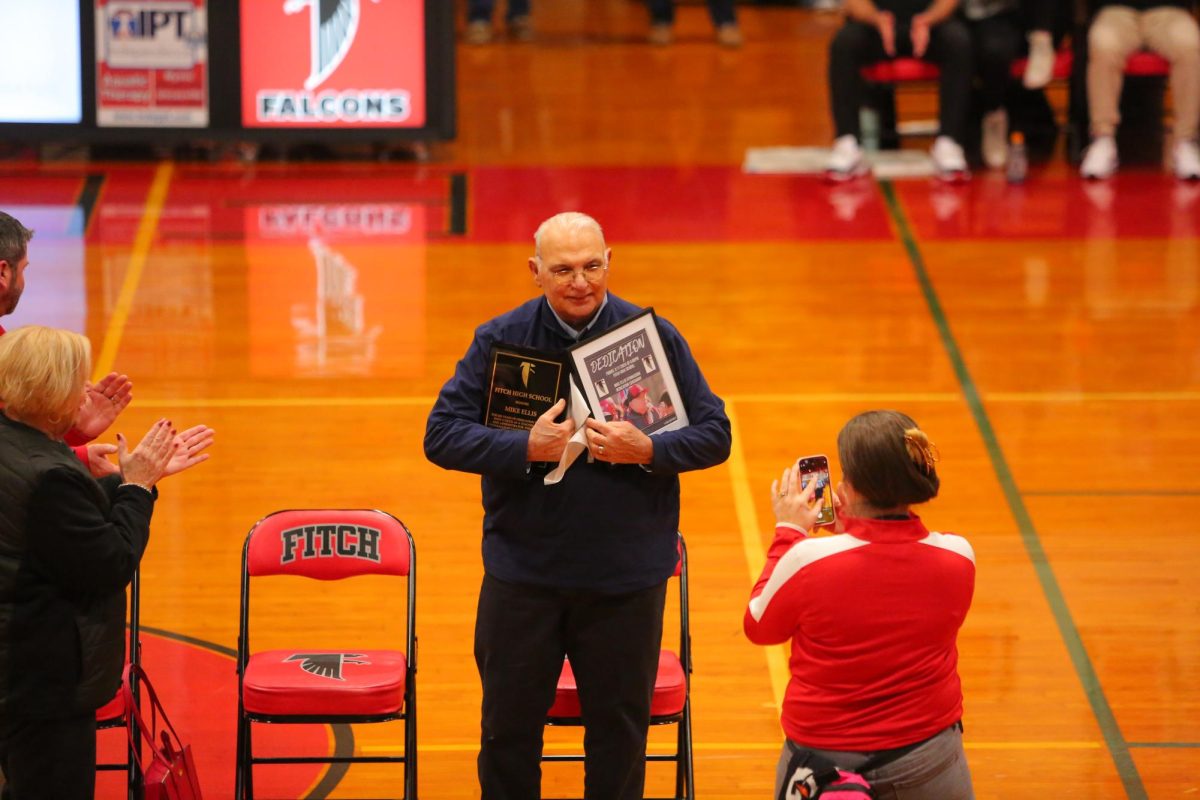 Coach Ellis receives his honors as the Mike Ellis Gymnasium is named after him. (Credit: Mark Russell)