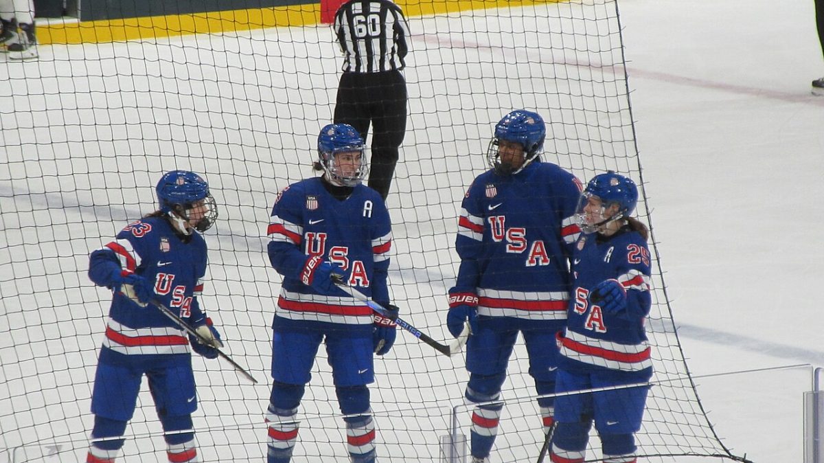 The U.S. Women's Hockey Team on the ice during their quarterfinal match against Italy. (Credit: Alex Sirac, https://commons.wikimedia.org/wiki/User:Exilexi)